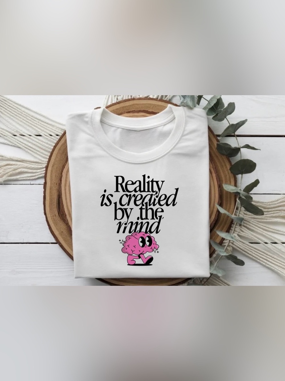 White Graphic Tee "Reality Is Created By The Mind" with Pink Brain Cartoon